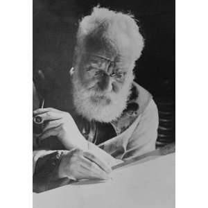 Alexander Graham Bell writing at his desk in his study in 