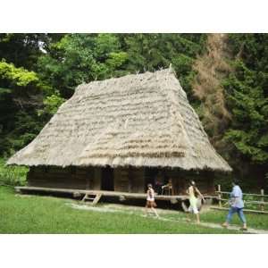  Tourists Visiting Traditional Thatched Roof House in the 