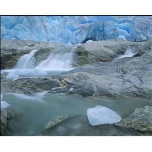 Glacier opening   blue glacier ice and glacial river at Nigardsbreen 