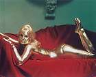 shirley eaton goldfinger painted gold on red couch pose returns
