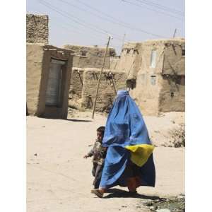 Lady Wearing Burqa Walks Past Houses Within the Ancient Walls of the 
