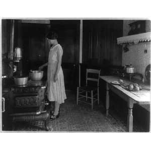  Farm woman cooking at stove in kitchen, 1925 1930